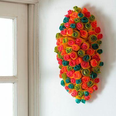 Flowers hanging up on the wall of a house